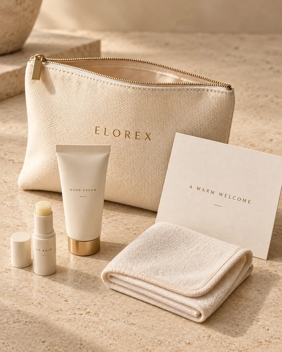 An Elorex canvas pouch with hand cream and lip balm, a folded washcloth and an 'A Warm Welcome' card